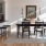 sunlight shines on dining area next to kitchen