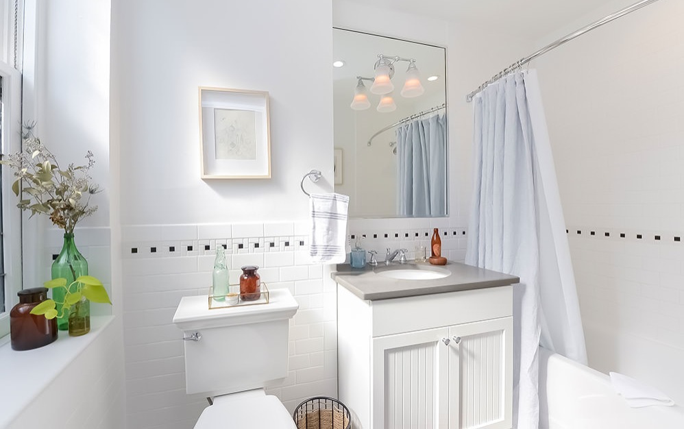 decorate windowsill in bright bath with shower/tub combo