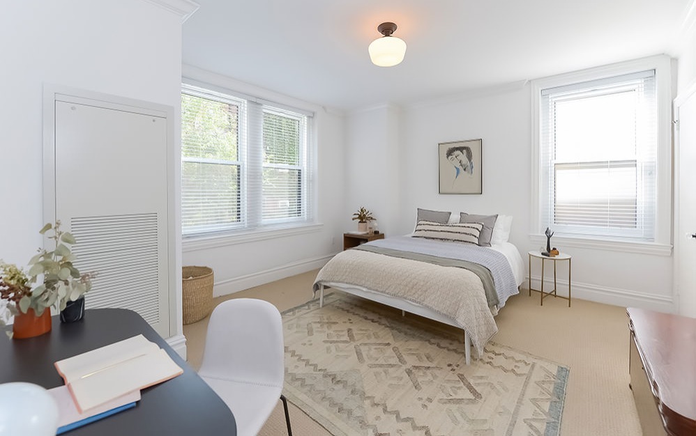 carpeted bedroom with ample natural light