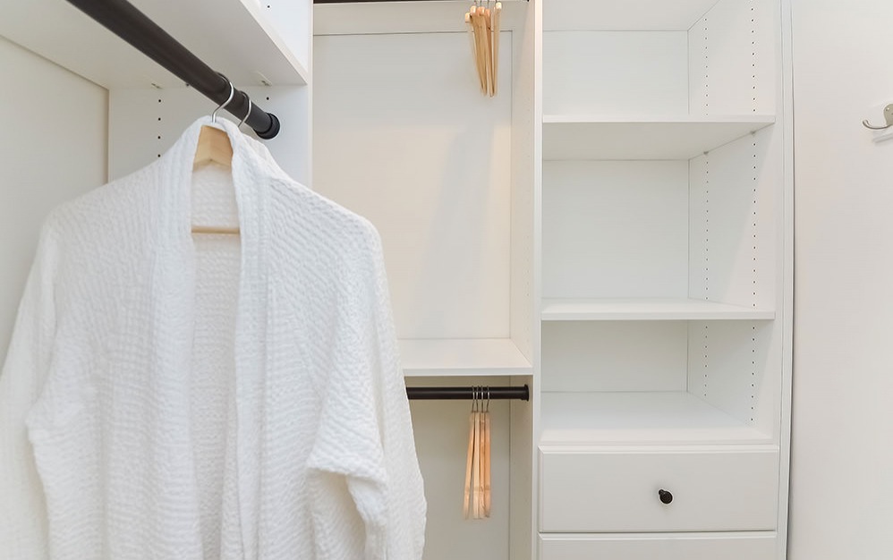 shelves and clothes rods in walk-in closet