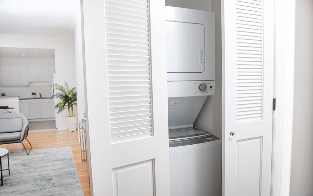 stacked washer/dryer unit in laundry closet