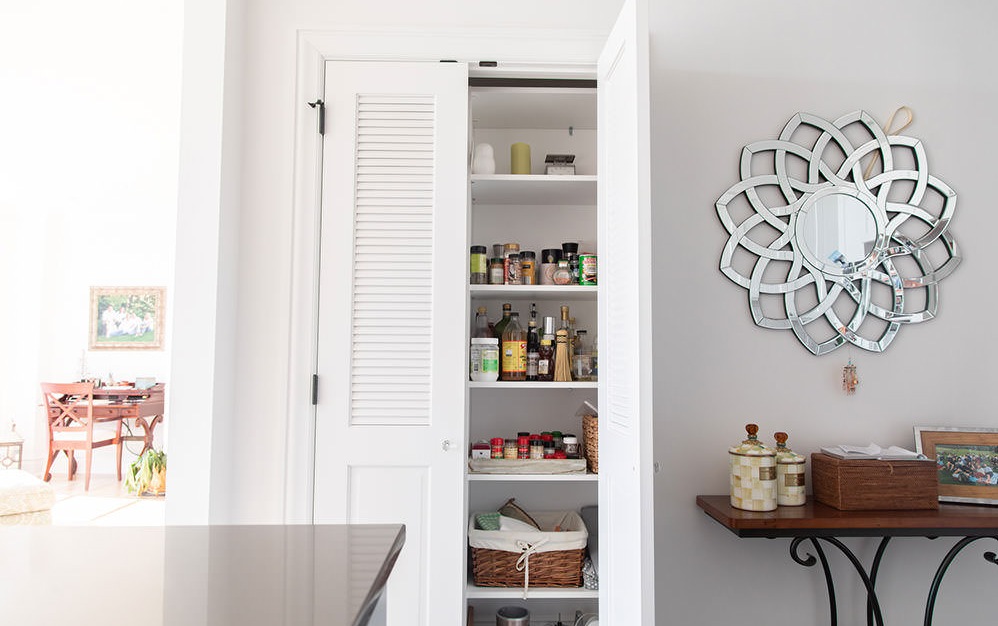 kitchen pantry with fold out doors
