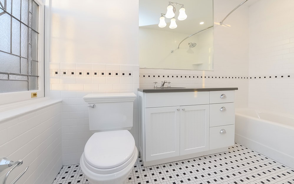 tiled bathroom with ample lighting