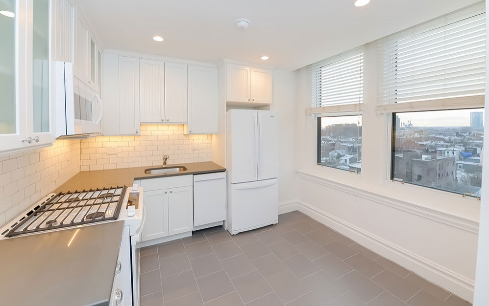 large windows in kitchen with gas stove top