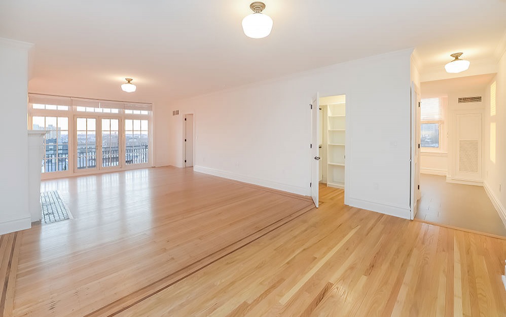 spacious living area with french doors leading to private balcony