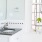 a bathroom with vanity sink next to a window