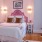 a bedroom with pink bedding